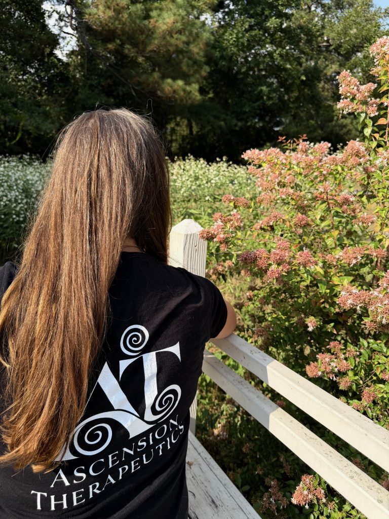 Professional picture of Ascension Therapeutics logo on back of T'shirt.